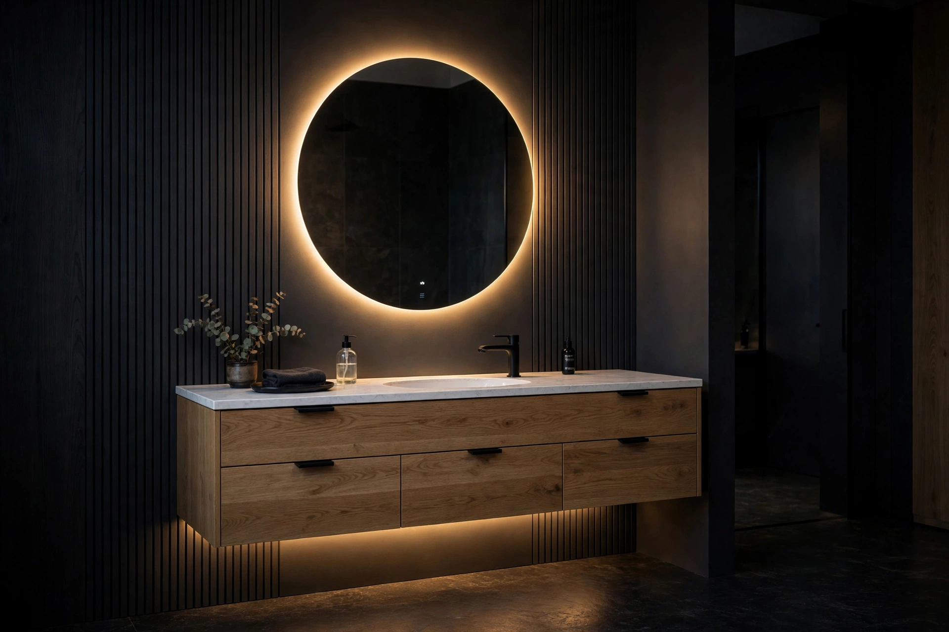 Floating vanity with a glowing backlit round mirror and warm under-cabinet LED lighting