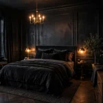 Moody boutique-hotel style bedroom with deep charcoal walls, layered warm lamplight and plush dark bedding
